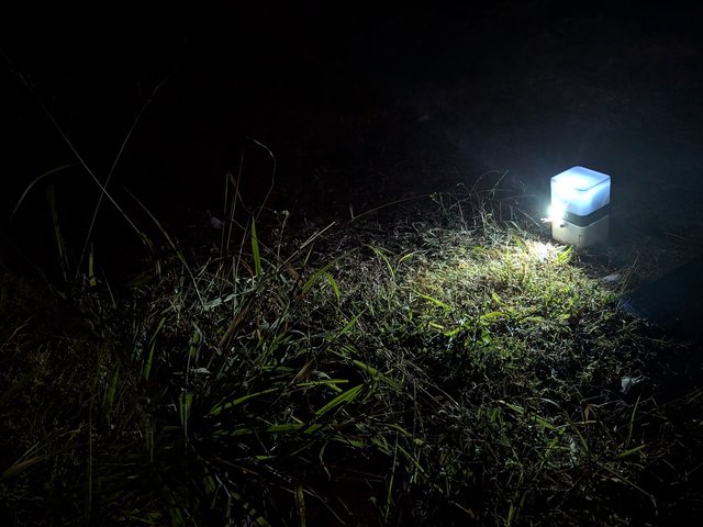 ToadTurret Lite illuminating the surrounding grass at night